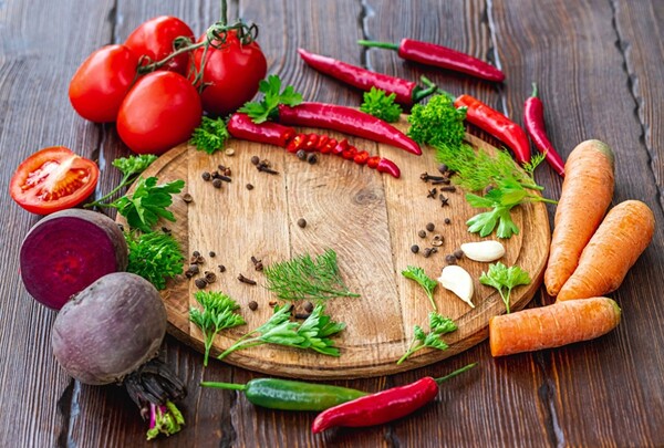 Chopping board with tomatoes and herbs prepared for a simple meal